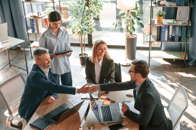 Successful deal doing handshake group of business people